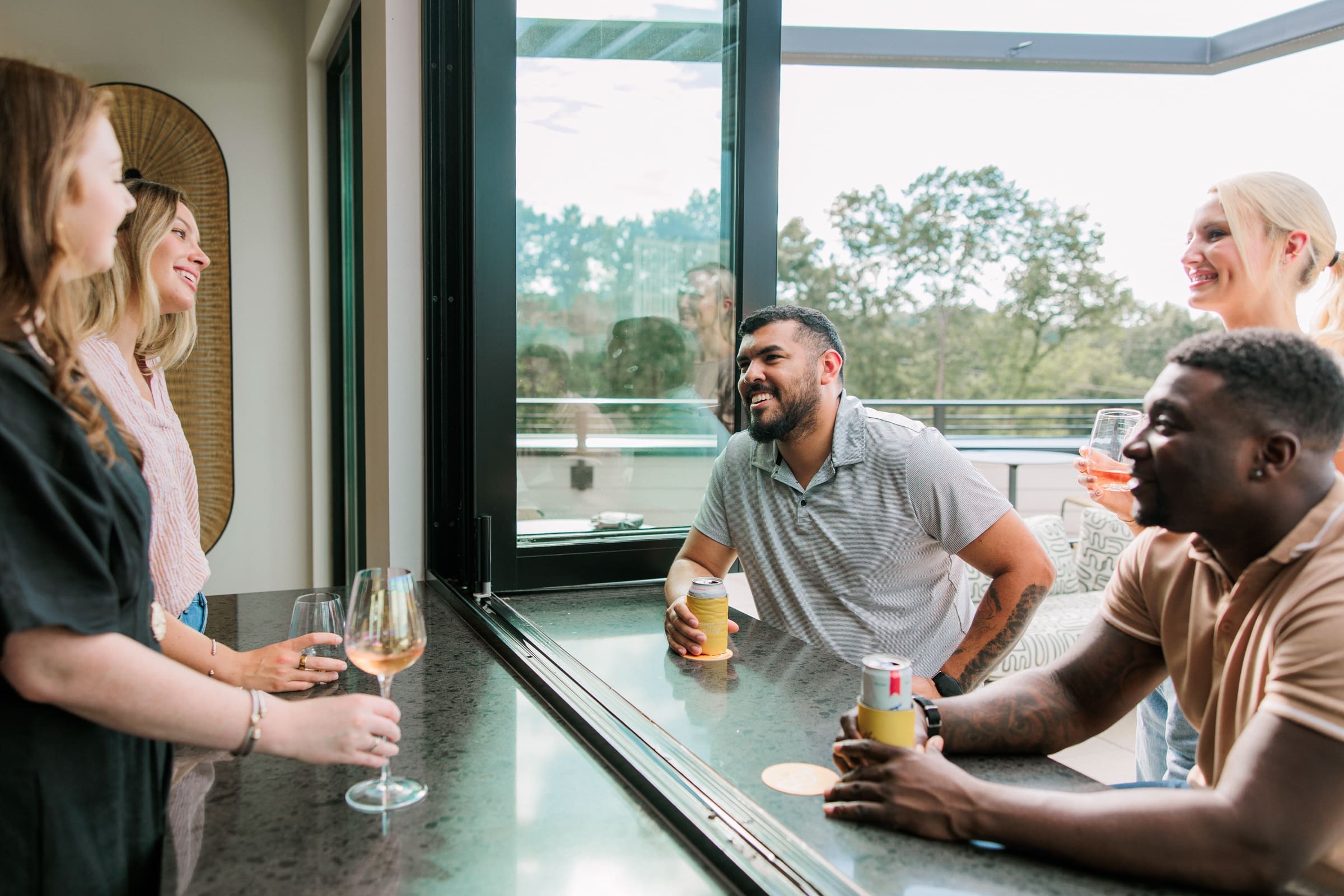 men and women drinking on roof top in downtown raleigh