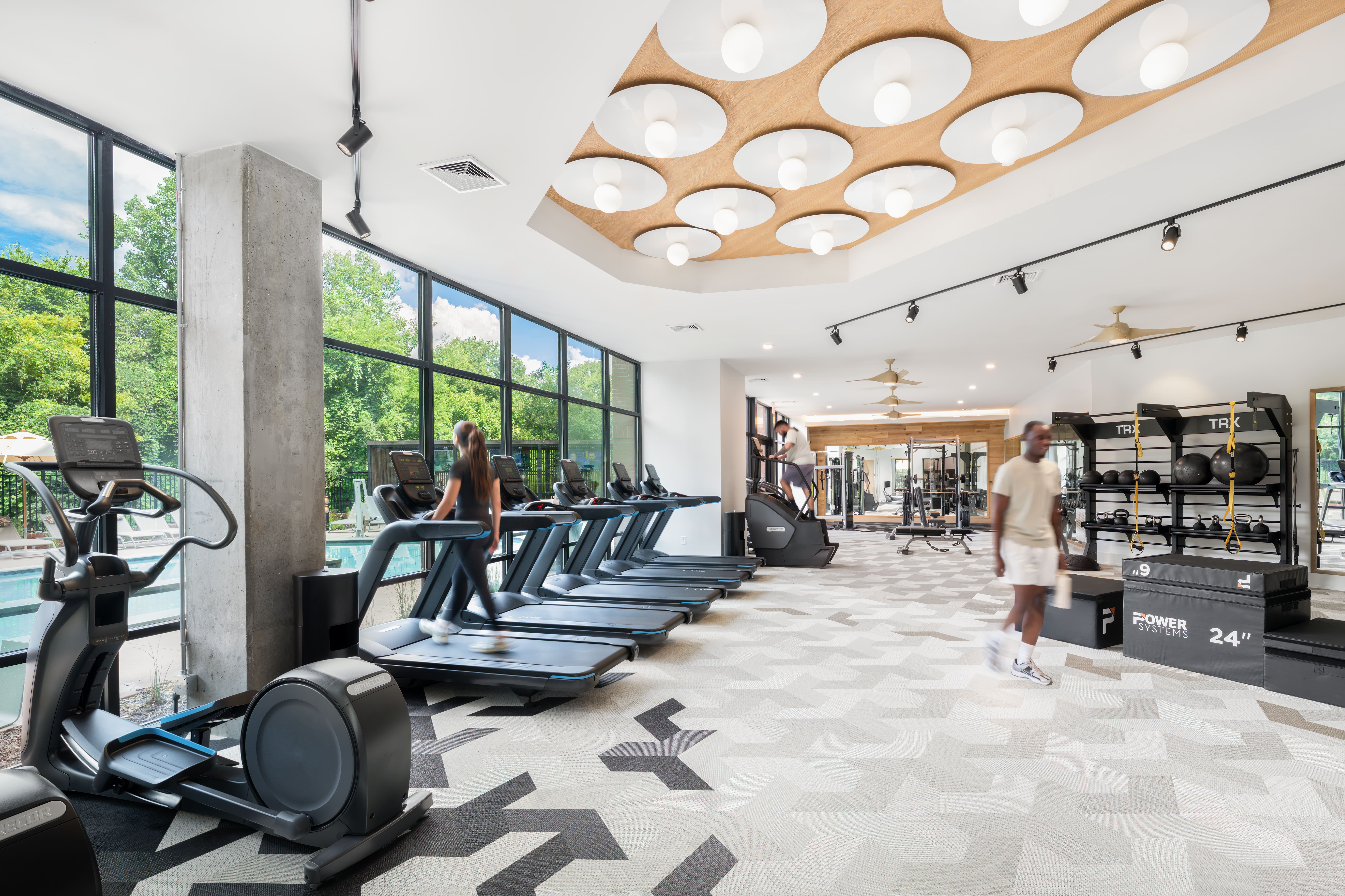 gym. woman on treadmill. man walking. man working out.